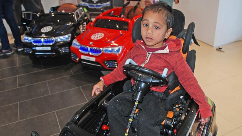 Three-year-old Ezekial can now drive himself, thanks to an adaptation which slots his wheelchair seat into his own electric BMW 